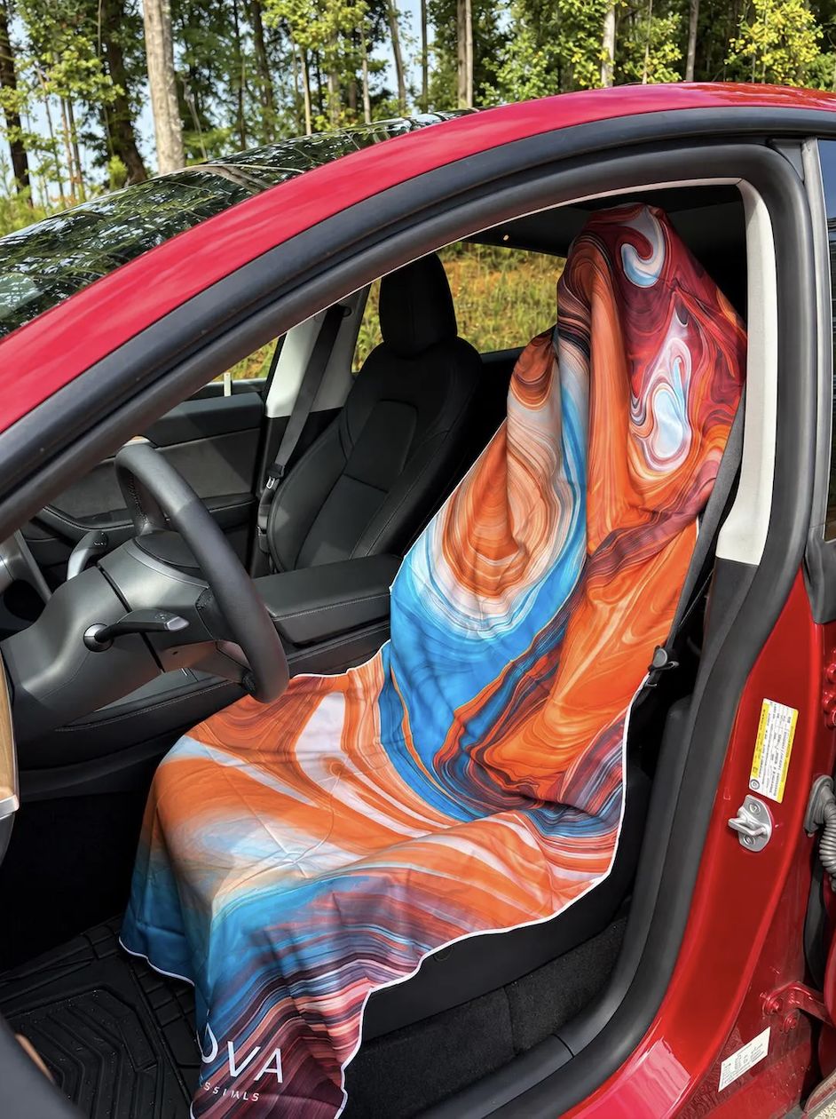 Orange swirl KOVA towel covering a car seat